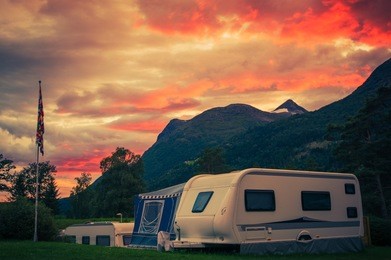 scenic camping sunset. sunset sky over campground with travel trailers. campsite caravan camping.