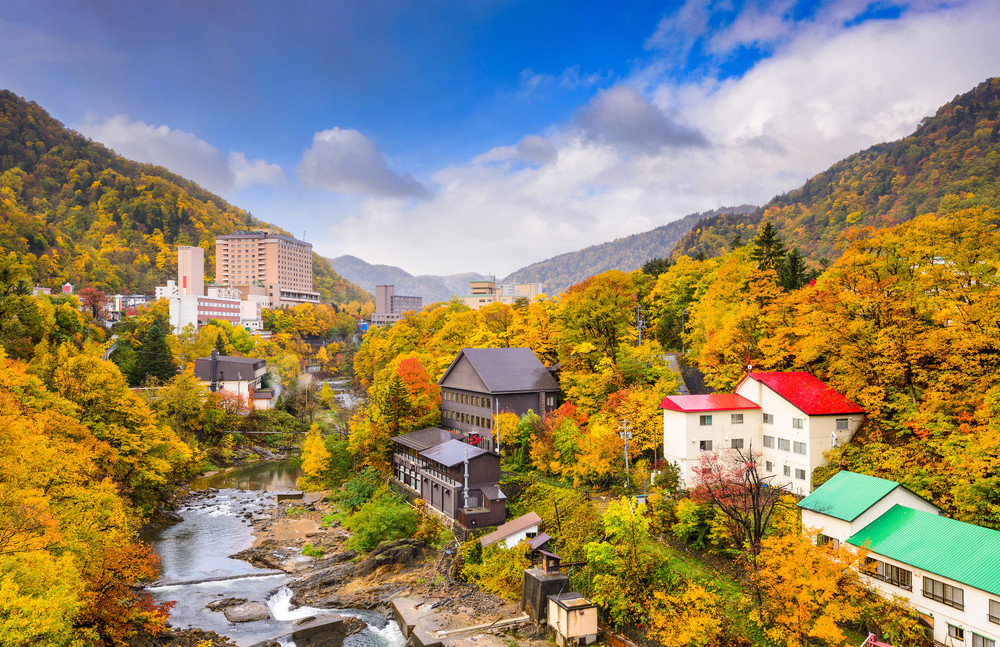 jozankei, japan inns and river skyline during the autumn season.