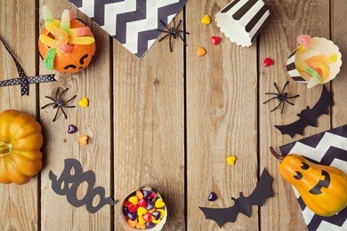 halloween holiday background with pumpkin and candy. view from above