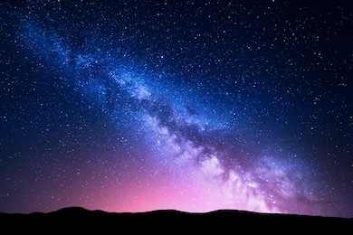 milky way and pink light at mountains. night colorful landscape. starry sky with hills at summer. beautiful universe. space background with galaxy. travel background