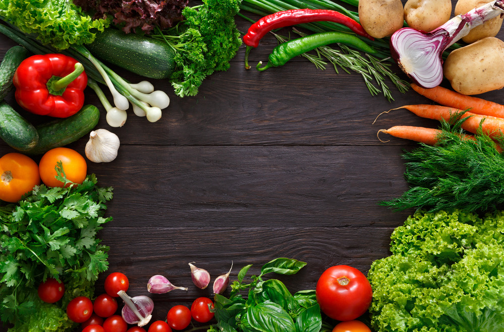 frame of fresh organic vegetables on wood background. healthy natural food on rustic wooden table with copy space. tomato, lettuce, carrot, pepper, zucchini and other cooking ingredients top view