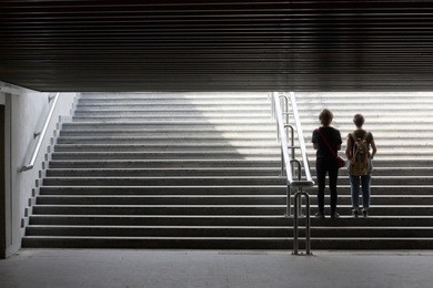 insight into the future. silhouette of young couple in the way out of underground. urban scene with metaphorical relation to lifestyle, education or social issues.