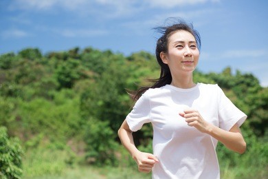 asian woman running in the park