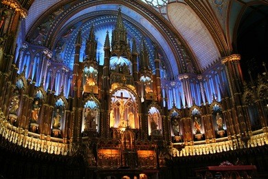 interior of the notre-dame basilica (basilique notre-dame) in montreal, canada with deep blue ceiling with golden stars and sanctuary in polychrome of blues, azures, reds, purples, silver, and gold