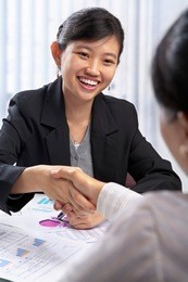 chinese businesswoman handshake with her client in the office