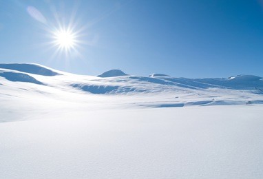 snowscape under blue sky and strong sun