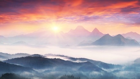  sunrise, the sun's rays illuminate the beautiful panorama of the carpathian village against backdrop of scenic mountains, where the highlanders live hutsul. wild forests, fields pastures