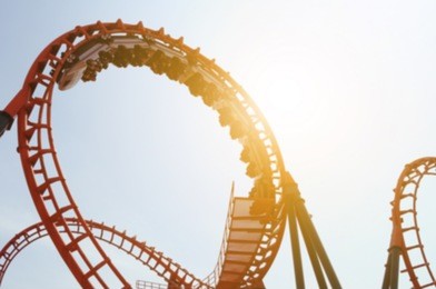blurred roller coaster ride in amusement park at evening