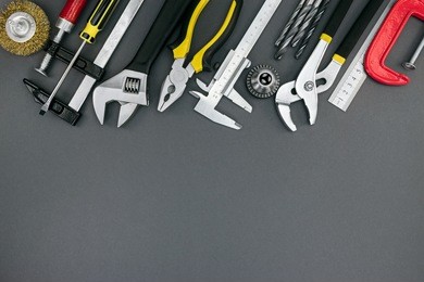 pliers and adjustable wrenches, ruler, clamp, vernier caliper on desk, hand tools top view