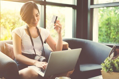 woman asian travelers she shopping online or in flight. by credit card at a coffee shop