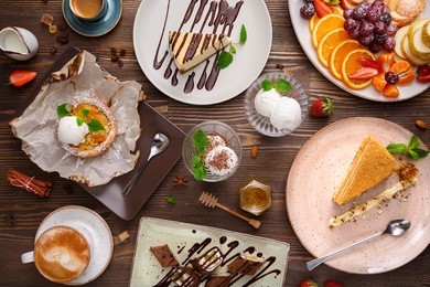 different desserts with fruits and coffee, top view