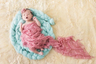 full body portrait of cute little baby girl yawn while sleeping comfy with copy space