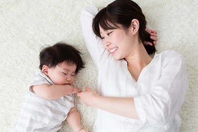 portrait of asian mother and baby sleeping in the room