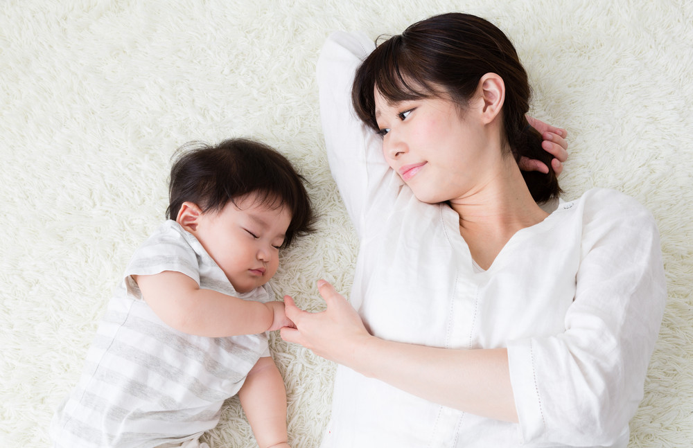 portrait of asian mother and baby sleeping in the room