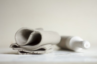 ceramic working process. pottery tool and clay. white clay