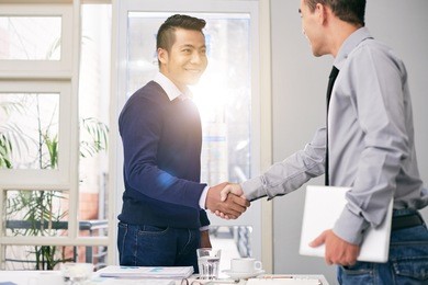 vietnamese business partners shaking hands before meeting