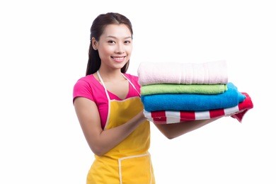a portrait of a young asian woman holding clothes