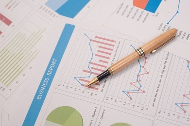 pen on paper report ,business finance, tax, accounting, statistics and analytic research concept