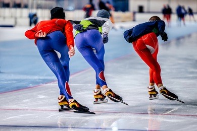 group of men skating on warm-up race before competitions in speed skating