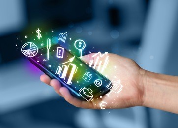 smartphone with finance and market icons and symbols concept