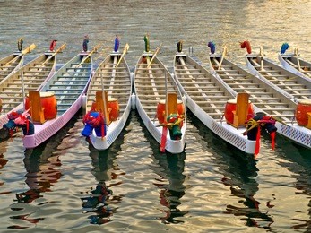 dragon boats basking in a warm sunlight before the race