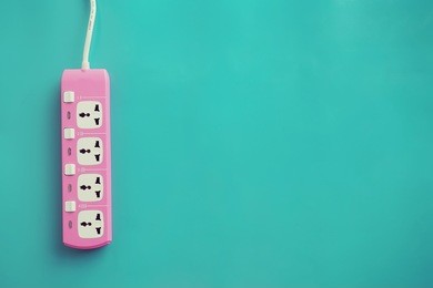 power plug socket on mint green background. flat lay. minimalism style.
