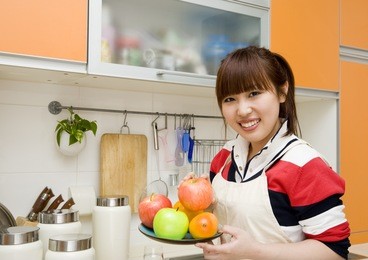 woman preparing food in her kitchen.
