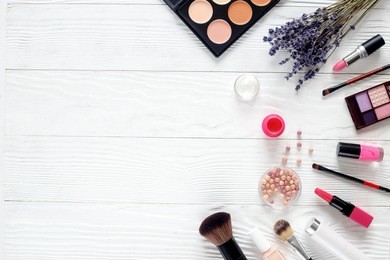 makeup set on white table with lavender top view