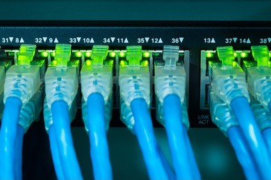 network gigabit switch and utp port cat 6 ethernet cables close-up in data server room
