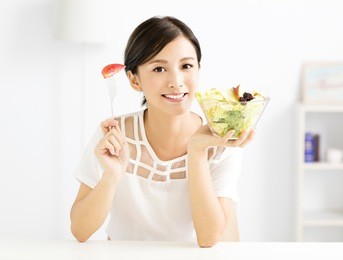 beautiful  young woman eating healthy food