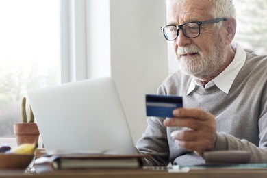 senior adult holding credit card concept