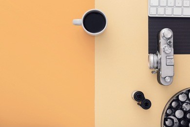 work space on orange table of a creative designer or photographer with laptop, cameras other objects of inspiration and copy space. stylish home studio concept of technology trends. view from above.