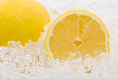 whole and cut lemons on crushed ice