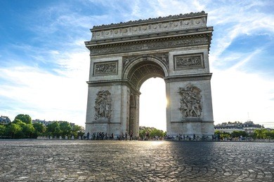 beautiful sunset over arc de triomphe at place de l'etoile, paris, france