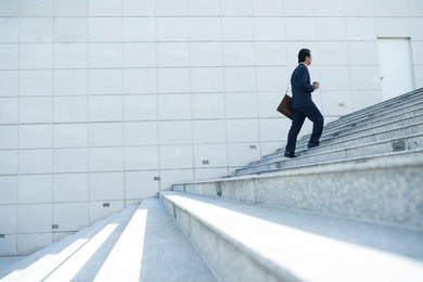 businessman walking up the stairs, side view