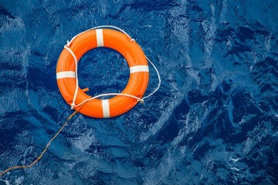 safety equipment, life buoy or rescue buoy floating on sea to rescue people from drowning man.