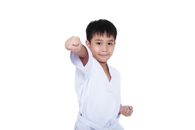 asian child athletes martial art taekwondo training, isolated on white background. cute boy with white belt in karate position, studio shot.