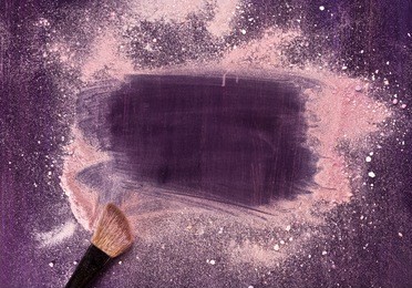 a makeup brush on a purple background, with traces of powder and blush on it forming a frame. a horizontal template for a makeup school business card or flyer design, with plenty of copyspace