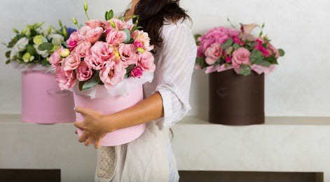 woman florist making a lovely flower composition in a flower shop