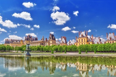 suburban residence of the france kings - beautiful chateau fontainebleau with the fountain on foreground. 