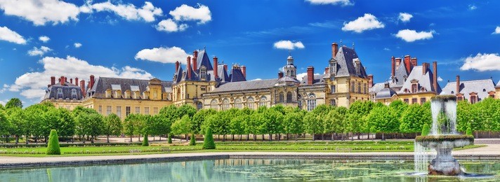 suburban residence of the france kings - beautiful chateau fontainebleau with the fountain on foreground. 