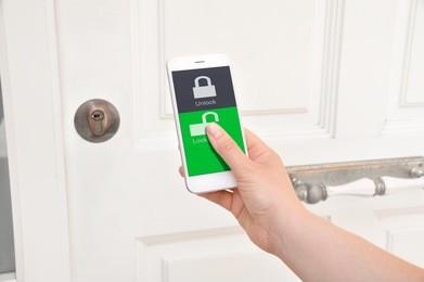 mobile smart phone use for open safety door and opens the door of his home.