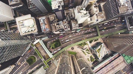 top view aerial photo from flying drone of a developed hong kong city with modern skyscrapers with contemporary design. china town with business and financial centers and road with cars