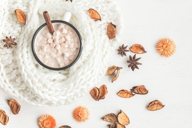 autumn. hot chocolate, knitted blanket, dried flowers and autumn leaves. top view, flat lay