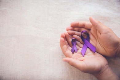 hands holding purple ribbons, toning copy space background, alzheimer's disease, pancreatic cancer, epilepsy awareness, hodgkin's lymphoma awareness