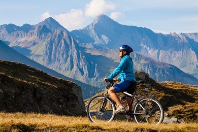 cyclist woman on the top of  hight mountais, dolomites, italy