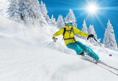 skier skiing downhill in high mountains