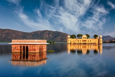 rajasthan landmark - jal mahal (water palace) on man sagar lake on sunset.  jaipur, rajasthan, india