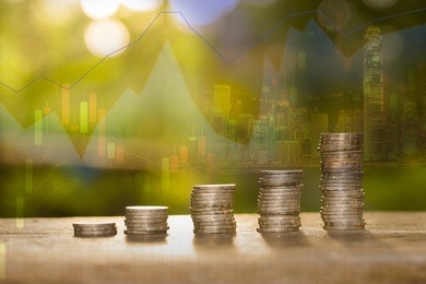 double exposure stack of pile money coins on trading graph and sunlight background. 
investment growth concept
