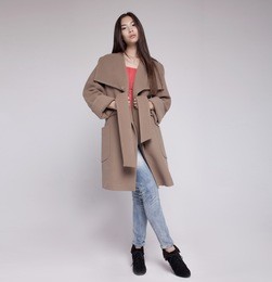 fashion asian model in autumn/winter clothes posing in light background